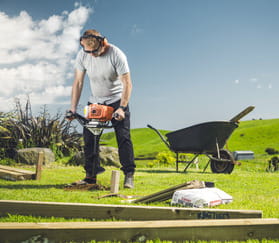 man using hole borer