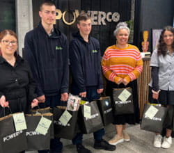 School students holding donation bags from Powerco