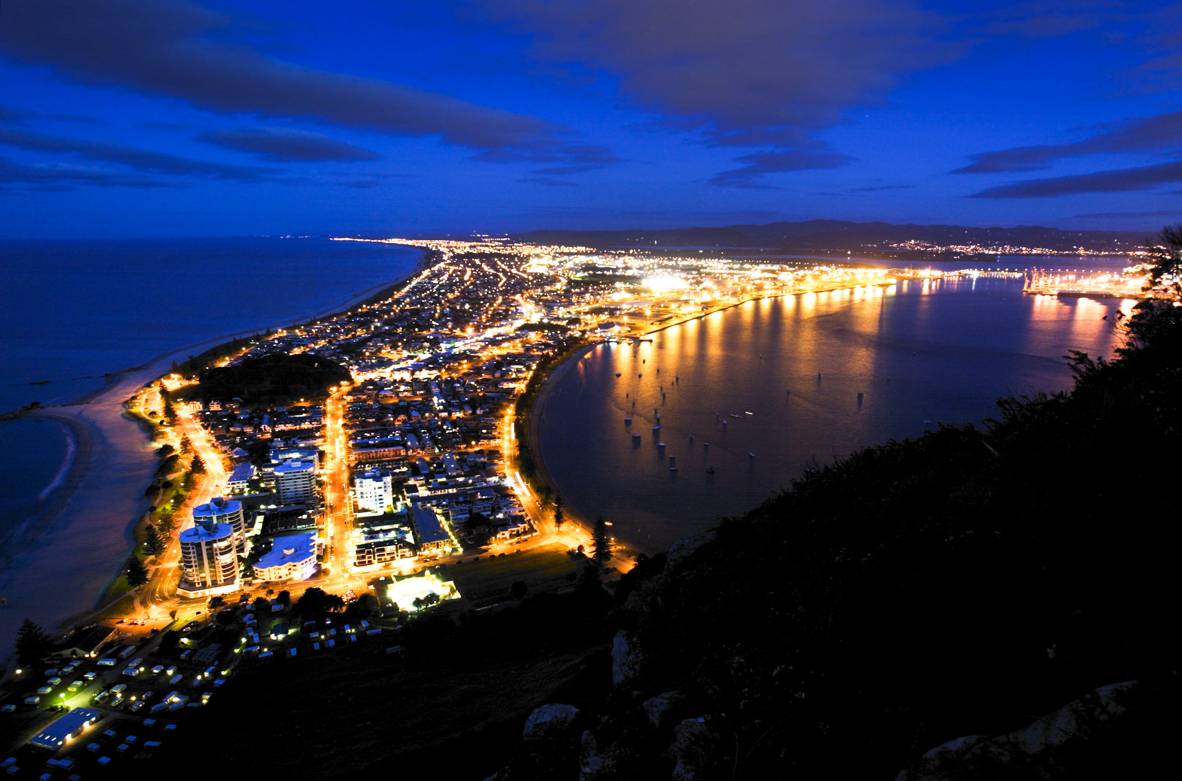 Aerial photograph of Mt Maunganui with night lights.